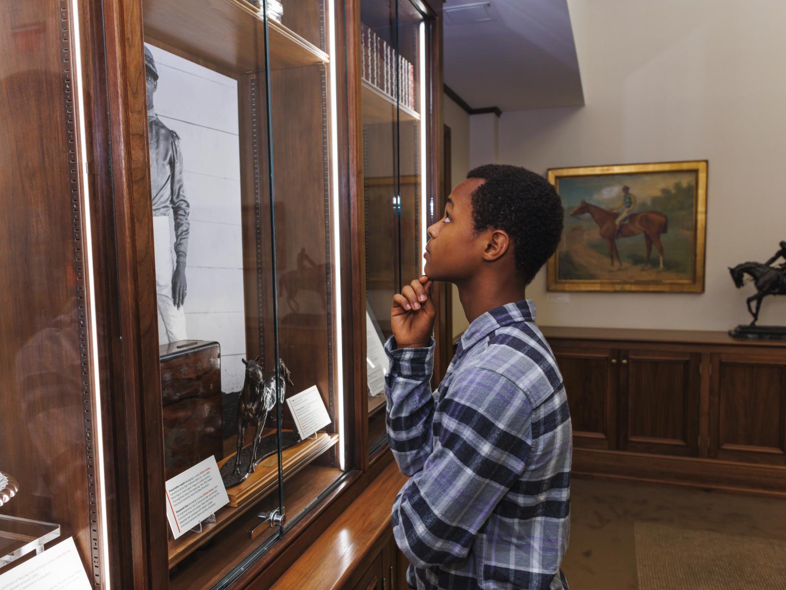 youth looking at display
